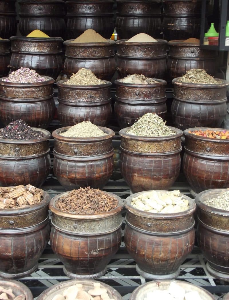 A spice market stall in Marrakech piled with colorful spices